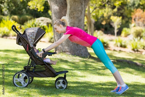 Woman exercising with baby stroller  photo