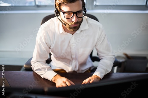 Businessman with glasses working on computer 