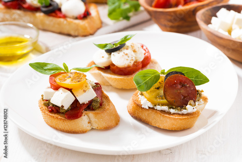bruschettas with tomatoes and mozzarella on plate