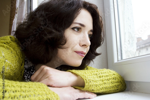 Beautiful women looking out the window photo