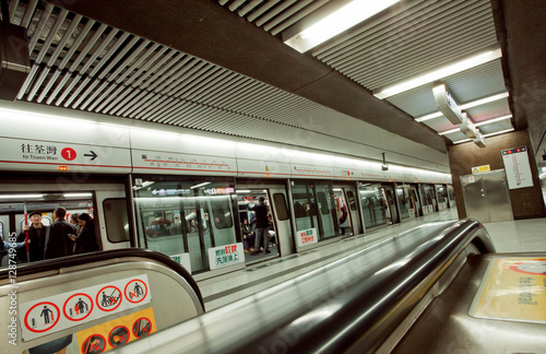Interior of the underground station of asian city and passengers inside trains