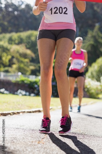 Female athlete standing on running track
