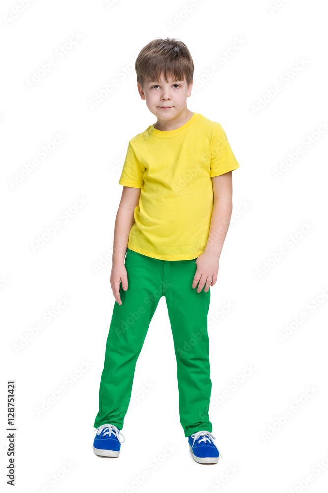 Smiling little boy in a yellow shirt stands Smiling little boy in a yellow shirt stands