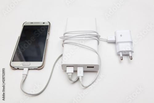 charging smart phone with portable battery on white backgrounds