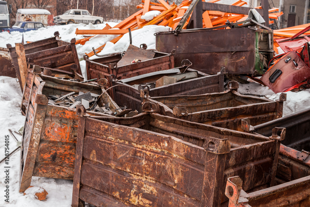 The pile of rusty metal boxes in the snow.