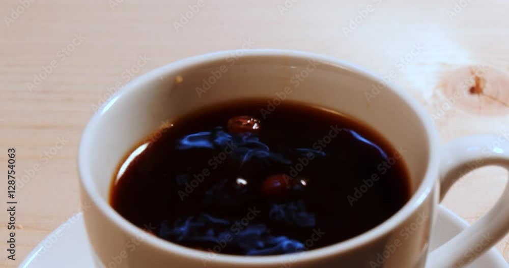 Falling coffee beans into a coffee. Falling coffee beans into a coffee.