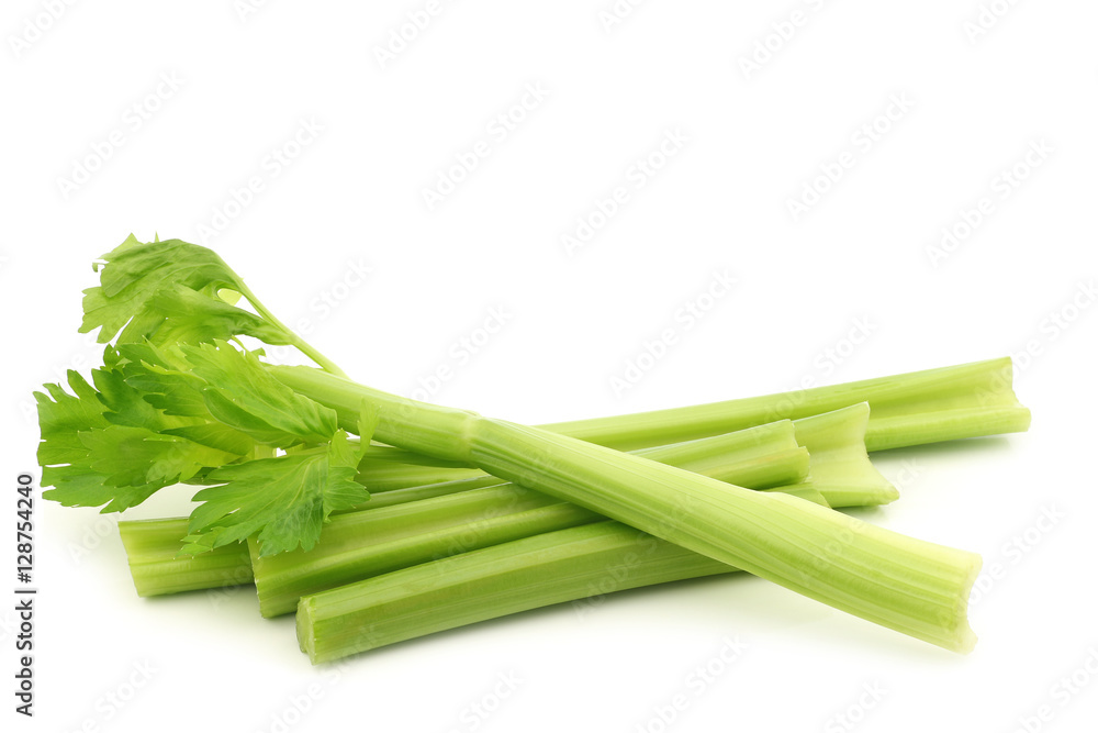 fresh celery stems on a white background fresh celery stems on a white background