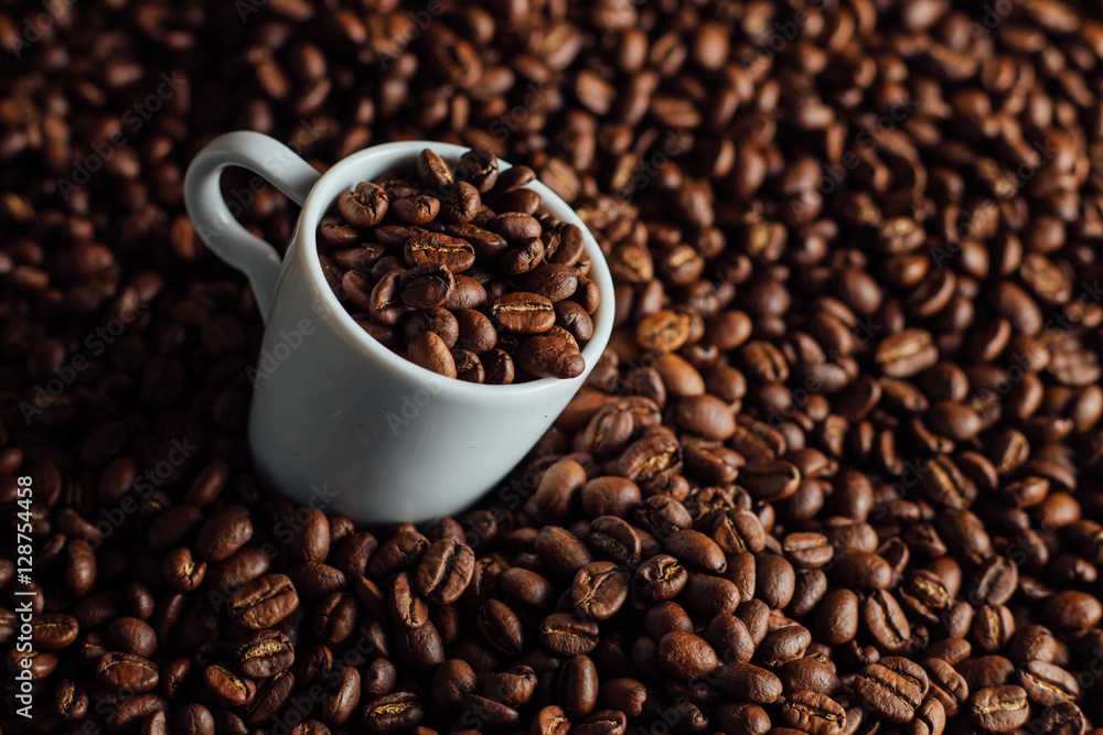 Espresso cup full of coffee on the grains pile. Italian traditional morning short drink on breakfast. Close-up. Toned Espresso cup full of coffee on the grains pile. Italian traditional morning short drink on breakfast. Close-up. Toned
