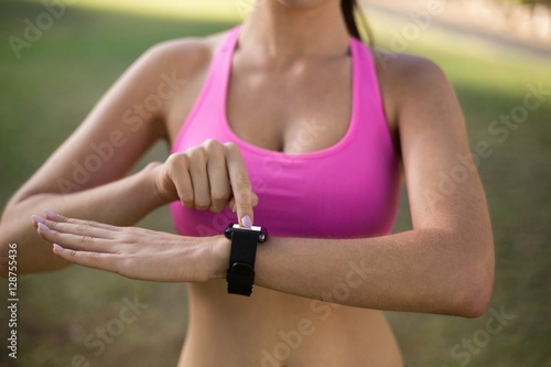 Woman adjusting a time on wristwatch