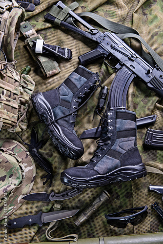 Modern military boots and weapon.Top view/Military boots,rifle,knife and other military equipment.Selective focus