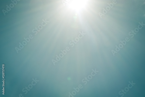 Realistic shining sun with lens flare on blue sky clouds nature day sky background vintage tone