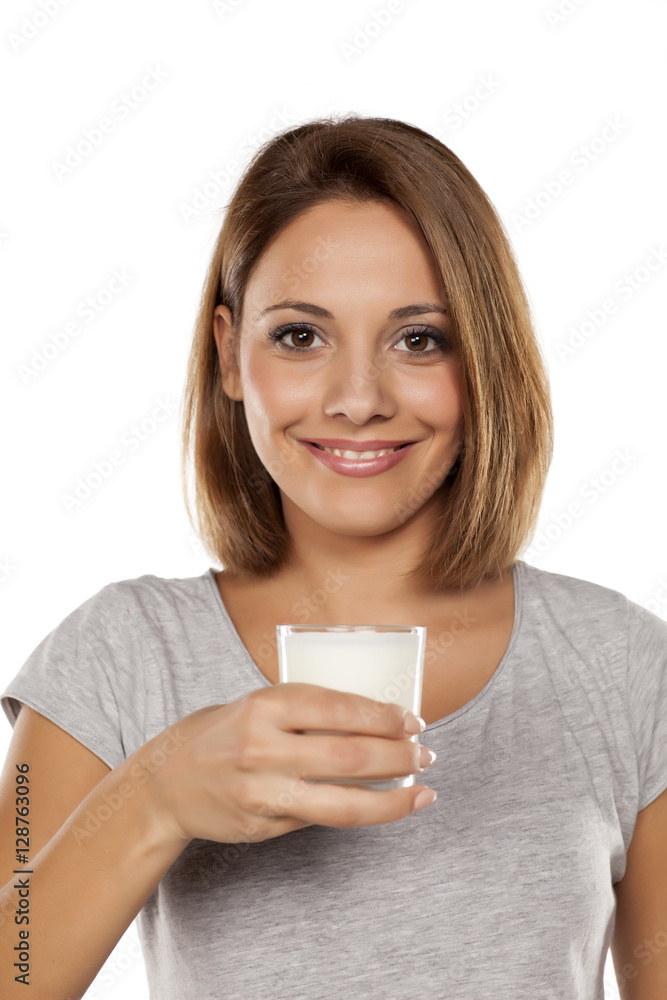 beautiful young woman holding a glass of milk beautiful young woman holding a glass of milk