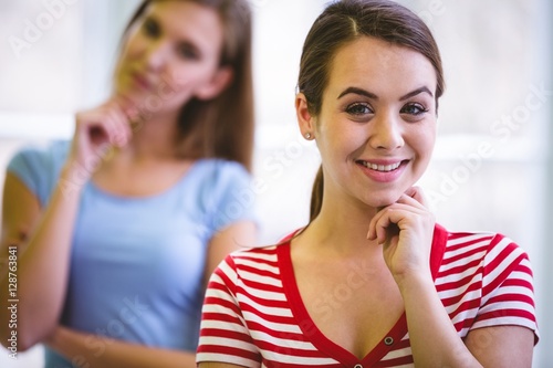 Portrait of happy executive with colleague in creative office