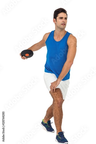 Male athlete playing discus throw on white background