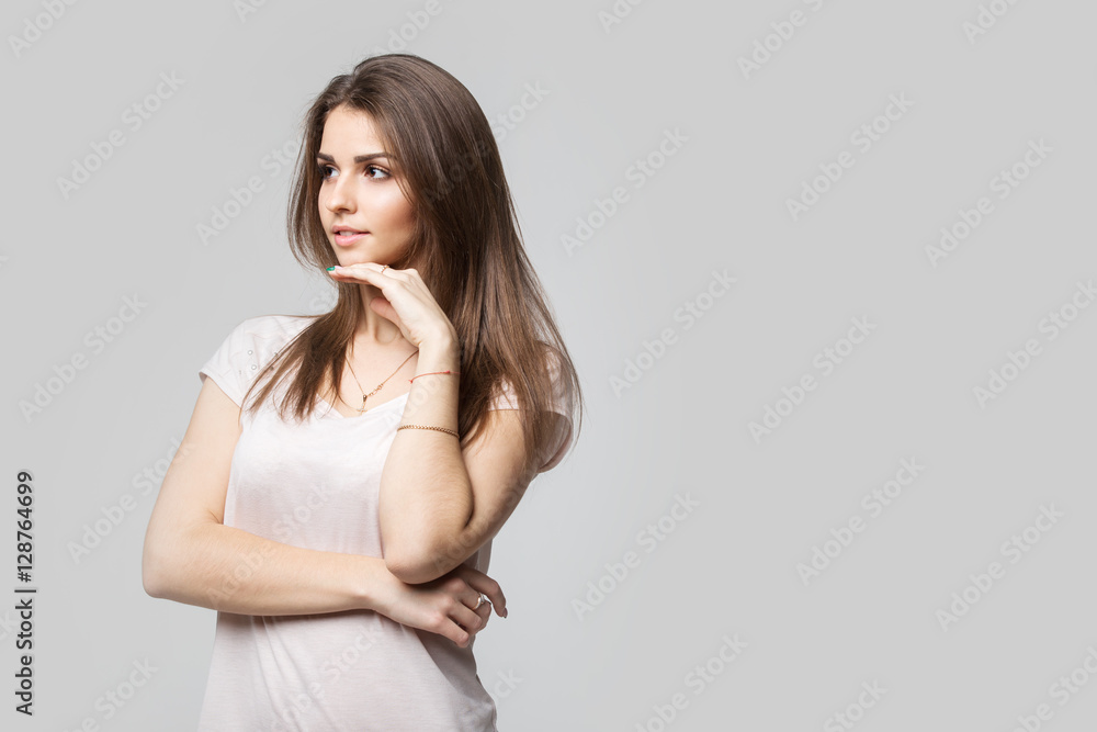 Portrait of beautiful brunette woman with natural make-up, on grey background Portrait of beautiful brunette woman with natural make-up, on grey background