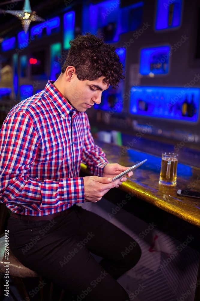 Man using digital tablet at bar counter Man using digital tablet at bar counter