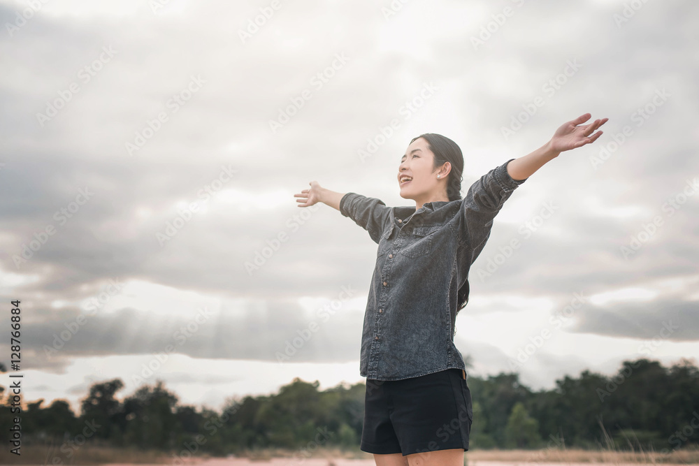 Young girl spreading hands with joy and inspiration facing the sun. Free Happy Woman Enjoying Nature. Beauty Girl Outdoor. Freedom concept. Beauty Healthy Girl over Sky and Sun. Enjoyment Young girl spreading hands with joy and inspiration facing the sun. Free Happy Woman Enjoying Nature. Beauty Girl Outdoor. Freedom concept. Beauty Healthy Girl over Sky and Sun. Enjoyment
