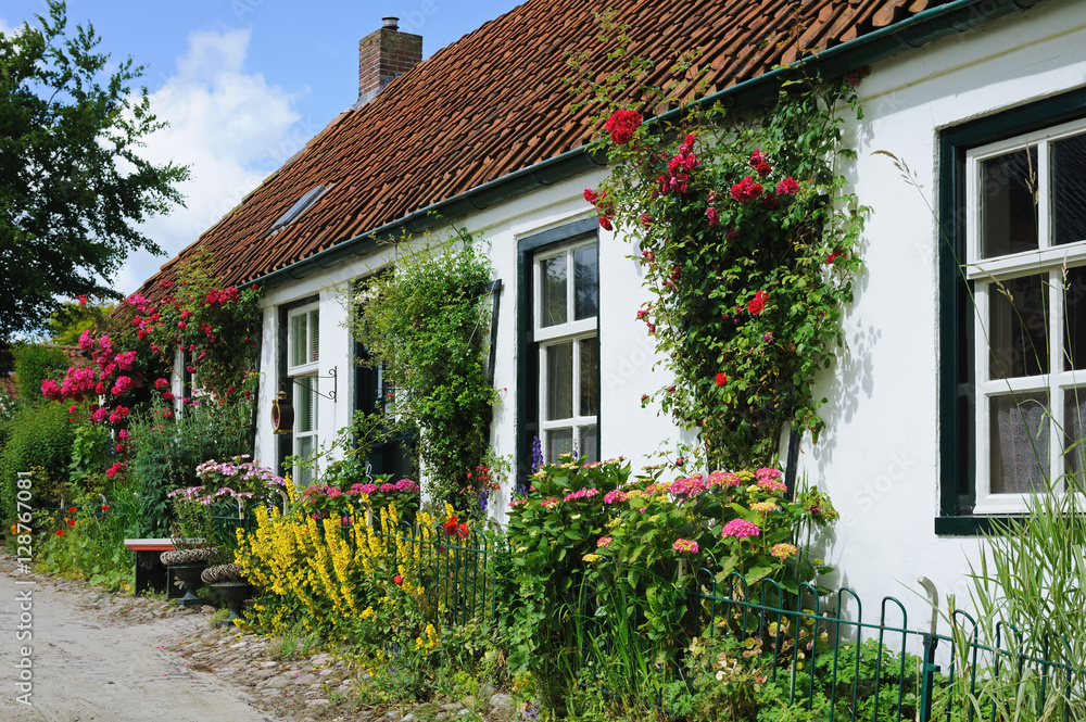 White Dutch house wreathed with flowers