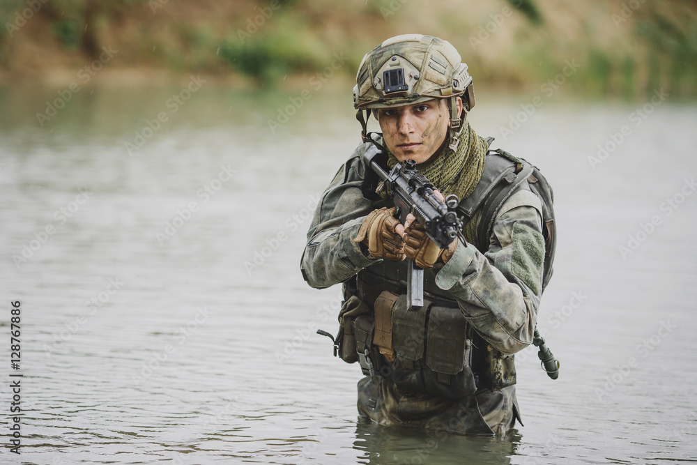 Fototapeta premium Portrait of a ranger in the battlefield with a gun