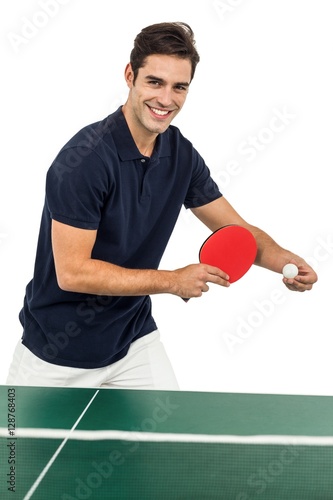 Portrait of male athlete playing table tennis
