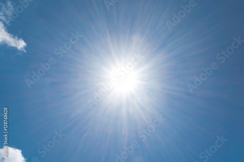 Realistic shining sun with lens flare on blue sky clouds nature day sky background
