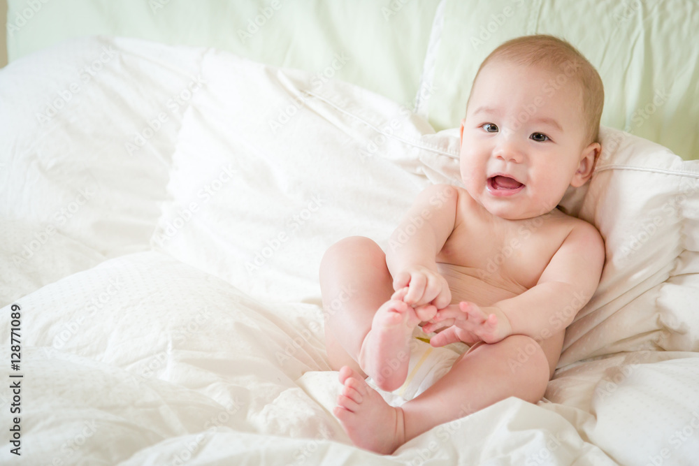 Young Mixed Race Chinese and Caucasian Baby Boy Having Fun on His Blanket. Young Mixed Race Chinese and Caucasian Baby Boy Having Fun on His Blanket.