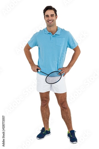 Portrait of badminton player standing with hands on hips