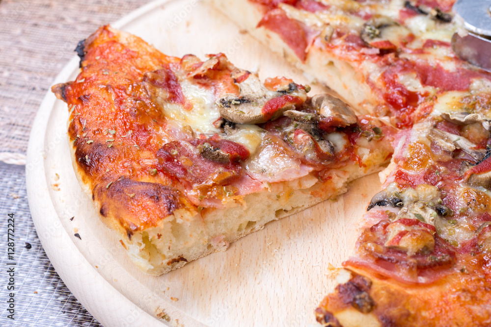 Closeup macro pizza slice on the wooden board Closeup macro pizza slice on the wooden board