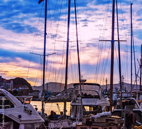 Yacht masts silhouette at beautiful twilight sky background in Bergen city marina, Norway
