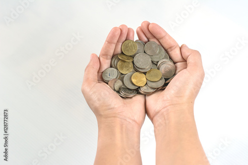 Hand stacking coins on white background