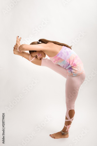 young woman yoga instructor demonstrates an asana