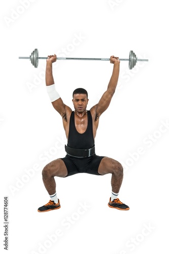 Bodybuilder lifting heavy barbell weights © WavebreakmediaMicro