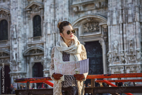 woman in front of Duomo in Milan with map looking into distance © Alliance
