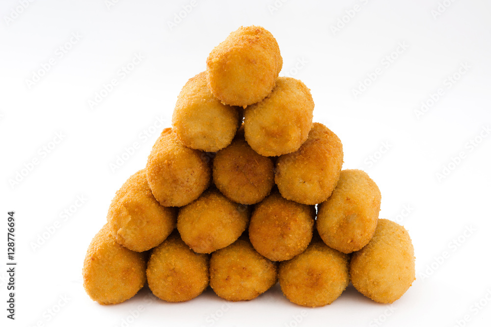 Traditional fried Spanish croquetas (croquettes) isolated on white background
