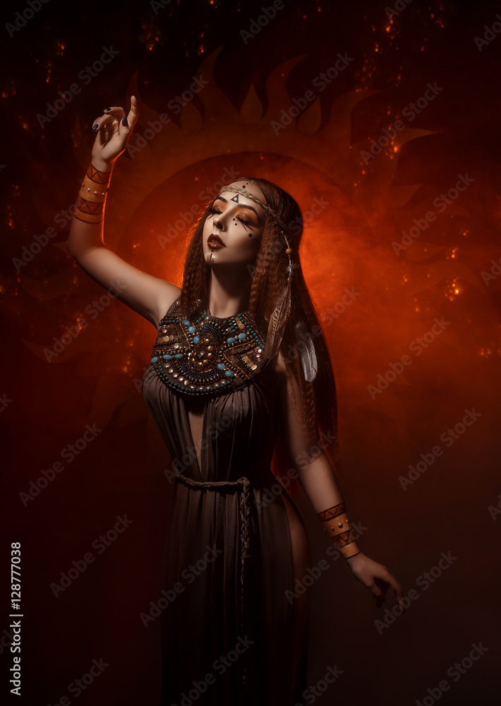 Beautiful, red-haired girl - a priestess of the sun. Dress and jewelry ...