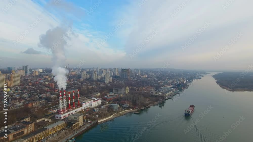 Modern aerial cityscape with a thermal power plant and river. Aerial view. Modern aerial cityscape with a thermal power plant and river. Aerial view.