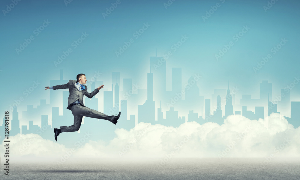 Businessman jumping high