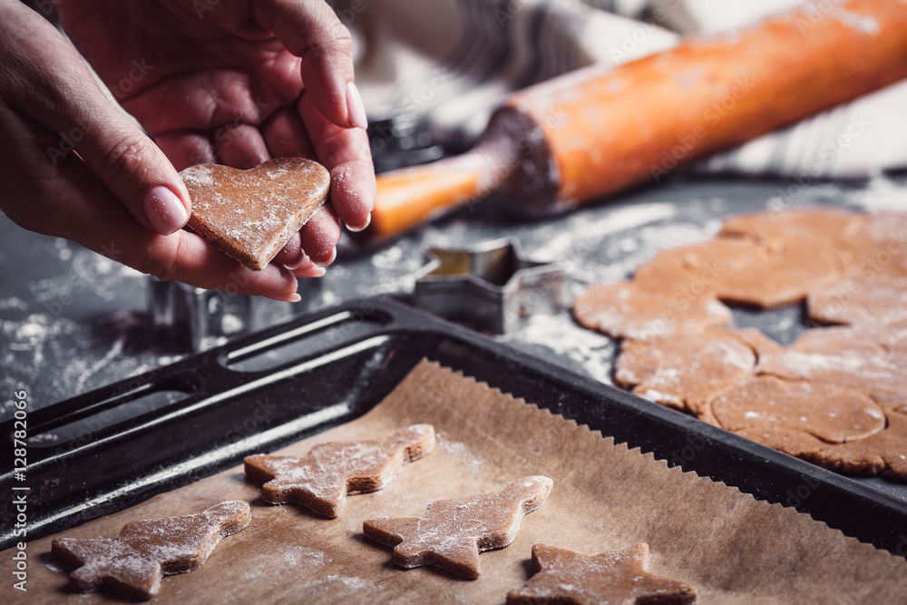 Cooking Christmas gingerbread cookies on a dark background Cooking Christmas gingerbread cookies on a dark background