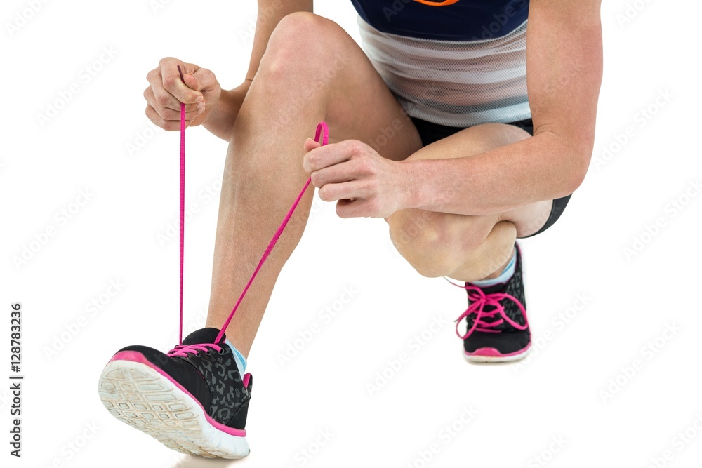 Athlete tying her shoe lace