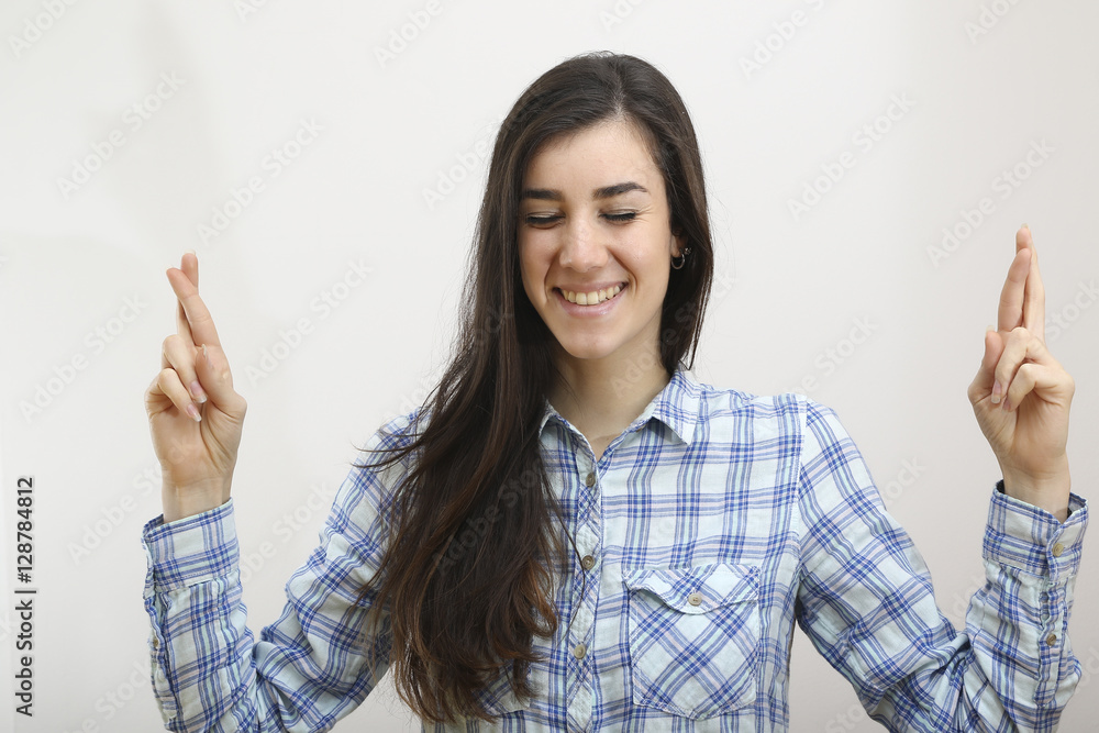 Portrait of happy woman with fingers crossed Portrait of happy woman with fingers crossed