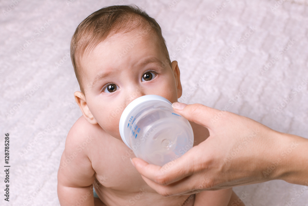 Cute little baby being fed from a bottle Cute little baby being fed from a bottle
