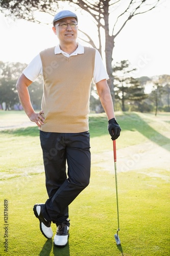 Portrait of golfer posing with his golf club