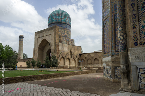 The large complex of Bibi-Khanym Mosque with the beautiful bright blue domes, rich mosaic decorations and old hieroglyphs on its walls, Samarkand, Uzbekistan.