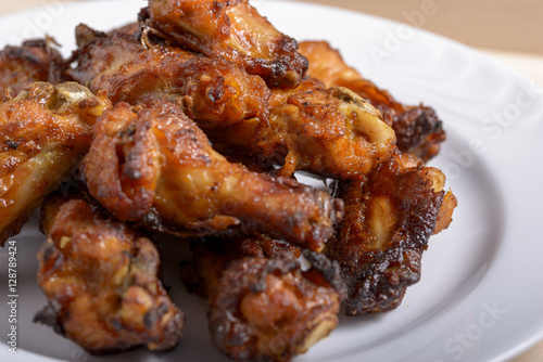 dish of spicy chicken wings on wood