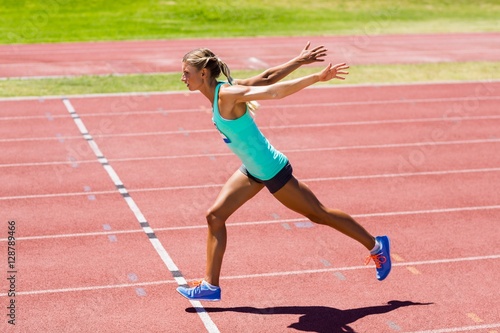 Female athlete running on the racing track