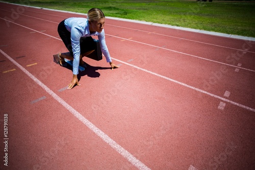 Businesswoman ready to run on running track © WavebreakmediaMicro