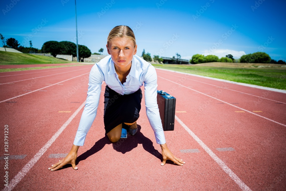 Portrait of businesswoman with briefcase ready to run