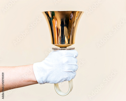 Close-up of girl holding metal bell in hand