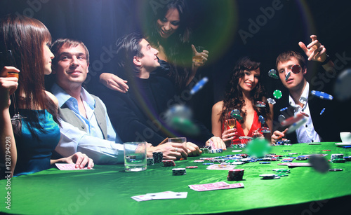Photography Poker players sitting around a table at a casino