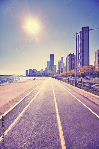 Retro stylized Chicago waterfront against the sun with lens flare.
